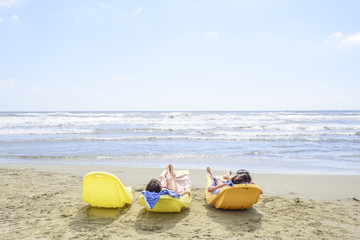 women relaxing on the shore of the beach