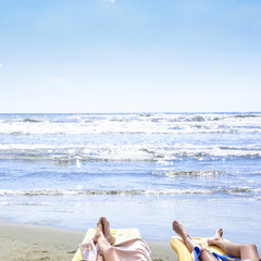 Fototapeta na wymiar women relaxing on the shore of the beach