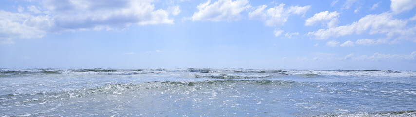 sea waves break on the sunny beach