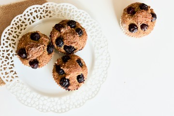 Tasty blueberry sweet muffins on the white plate.