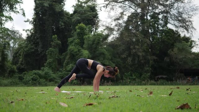Beautiful woman is doing Yoga in Park