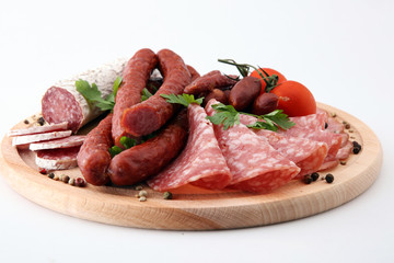 Food tray with delicious salami, pieces of sliced ham, sausage, tomatoes, salad and vegetable - Meat platter with selection - Cutting sausage and cured meat