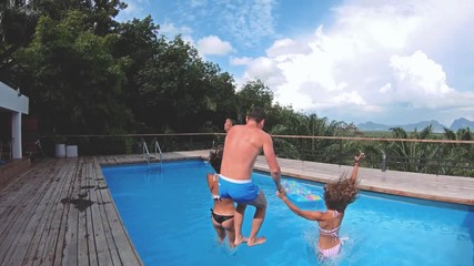 Group of happy friends drinking jumping in pool sunset party - Young diverse culture people having fun in tropical vacation - Holiday, youth and friendship concept - Powered by Adobe