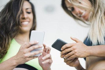 Two girls interacting with the smartphone