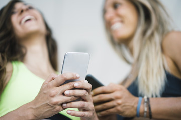 Two girls interacting with the smartphone