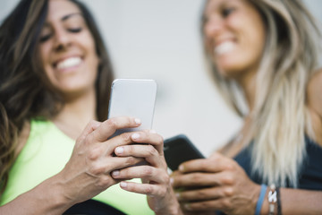 Two girls interacting with the smartphone