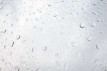 Rain drops on the glass against a stormy sky.