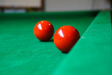 red snooker ball on snooker table