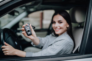 happy learner driver young woman smiling portrait with car keys