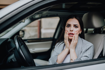 Shocked scared woman while driving the car