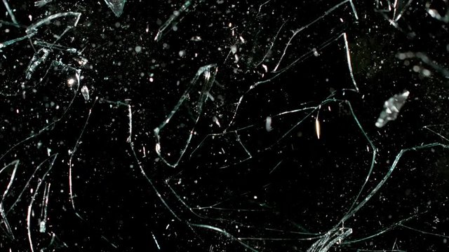 Super slow motion of shattered glass on black background. Filmed on high speed cinema camera, 2000 fps.