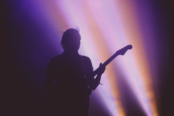 Silhouette of an unrecognizable guitar player