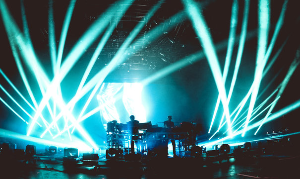 Sihouette of a music band in a concert full of lights