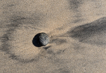 Fototapeta na wymiar Black rock on beach