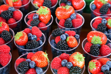 set of different berries in glasses