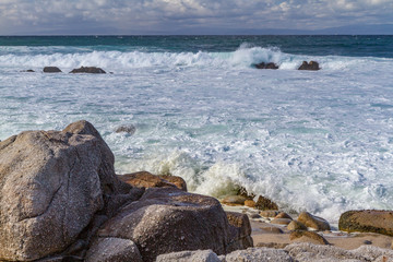 Foamy Surf and Boulders on the Shore at pacific Grove