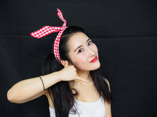 Portrait of good looking sexy Chinese woman with long black hair, pink hair ribbon and white halter...