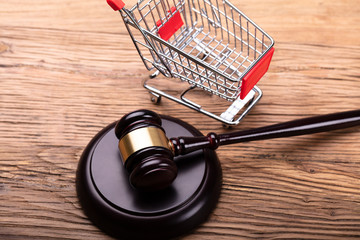 Judge Gavel And Shopping Cart On Table