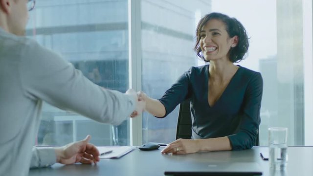 Beatiful Young Businesswoman Negotiates with a Potential Partner and Shakes Hands When them come to a Agrement. Strong Independent Woman in Business Situation. In Slow Motion.