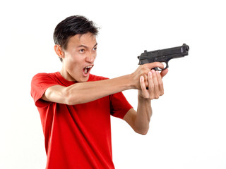 Fototapeta na wymiar Young man with plastic toy gun on white background. One Alone person.