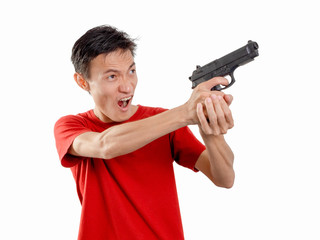 Fototapeta na wymiar Young man with plastic toy gun on white background. One Alone person.
