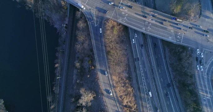 Top Down View of a Highway Junction and Train Tracks by the River