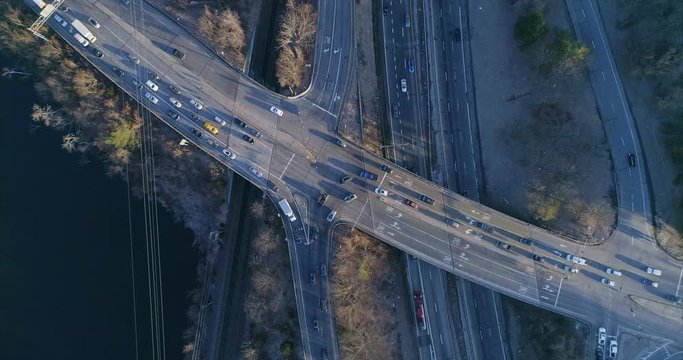 Top View Zooming Out of a Highway Junction and Train Tracks by River