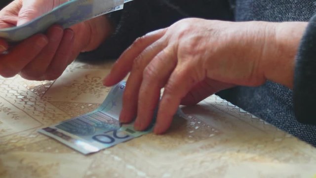 Senior lady counting euro banknotes, selective focus, very shallow DOF, very closeup shot