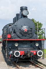 Obraz na płótnie Canvas Front view of an old-fashioned steam locomotive