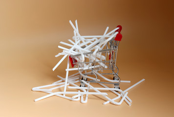 white disposable plastic straws in a shopping cart