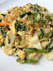 Dry sukiyaki fried vermicelli with mixed vegetables in sukiyaki sauce no meat in white plate on white background. Healthy and Vegetarian Food.