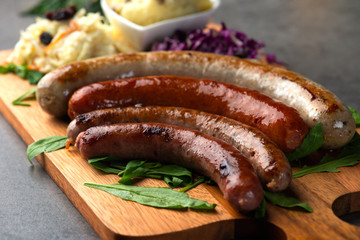 Grilled sausages with mash potatoes on table