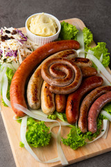 Grilled sausages with mash potatoes on table