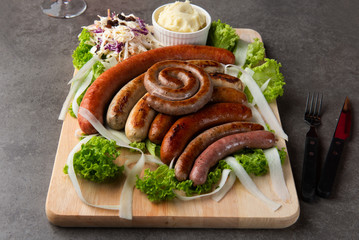 Grilled sausages with mash potatoes on table