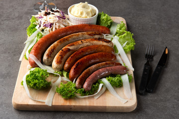 Grilled sausages with mash potatoes on table