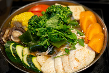Selective focus on rice noodles of Tawanese vegetarian boiling pot ready to eat, dinner angle, close-up