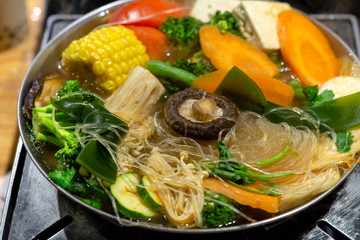 Selective focus on rice noodles of Tawanese vegetarian boiling pot ready to eat, dinner angle,...