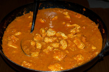 Chicken tikka masala  Indian on stovetop close-up top view