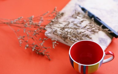 Dried flower closeup orange texture with coffee cup and diary blur background