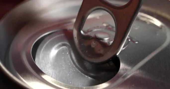 Open the can of soft drinks.