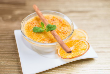 cheese dessert in a glass with mint and cinnamon stick