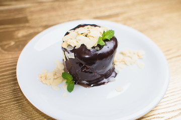 chocolate dessert with mint on a white plate