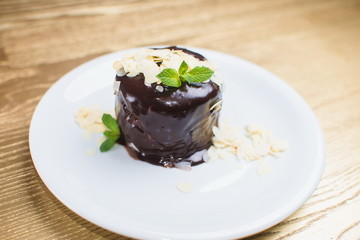 chocolate dessert with mint on a white plate