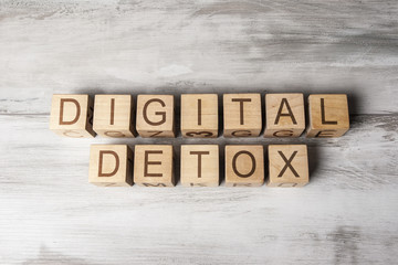 DIGITAL DETOX text on wooden cubes on wooden background