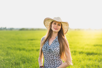 Beautiful smiling woman on a green grass outdoor