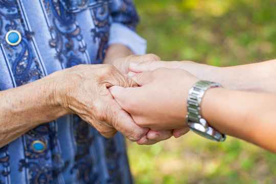 Holding elderly wrinkled hands