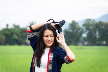 Naklejka premium Traveler women taking photo with old fashioned camera. background the nature field rice .Happy tourist woman enjoy and relax serenity vacation. Lifestyle and Travel