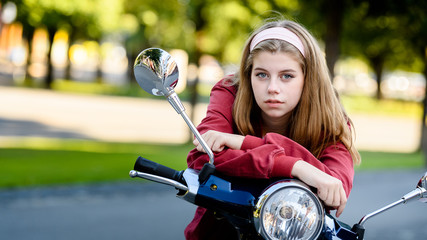 Fototapeta na wymiar Young girl student with motorbike