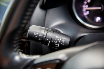 Auto and Multi functional wipers mode selector, modern car interior details. Close up photo with selective focus