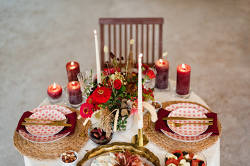 Luxury table settings for fine dining with candles and glassware, beautiful blurred background. For events, weddings. Preparation for holiday or romantic evening in loft interior